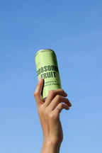 Slim Can Mockup CF32 – Held Upward, Blue Sky