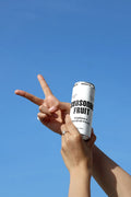 Slim Can Mockup CF10 – Held Against Blue Sky